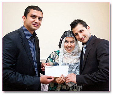 Adeem Younis presents Fawad and Farhan with Umrah Tickets.